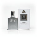 Creed Himalaya perfume bottle and packaging on a textured surface with flowers in the background.